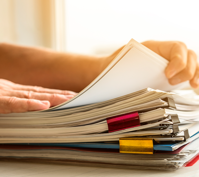 Photo of Pair of Hands on Papers