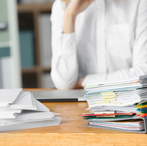 Photo of Person in Front of Stack of Paper