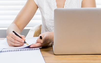 Photo of Student Writing on Paper