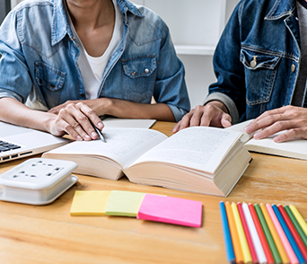 Photo of Two Students Studying